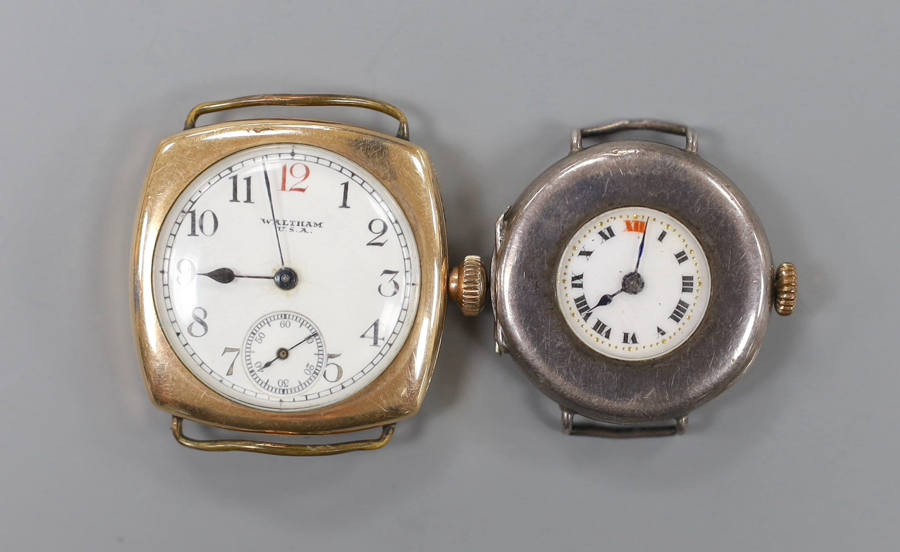 A gentleman's gold plated Waltham manual wind wrist watch and a silver manual wind wrist watch, both without straps.